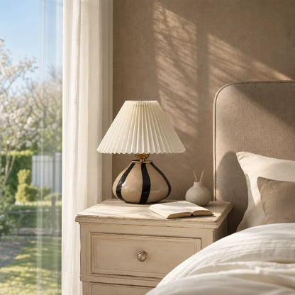Pleated fabric lamp with ambient lighting