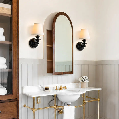 Wall sconce with curved support arm